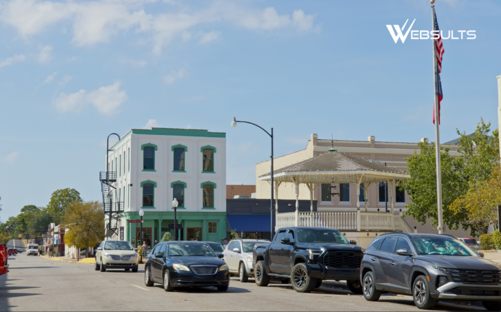 Downtown Brenham, Texas, street scene with historic buildings, parked cars, and a gazebo