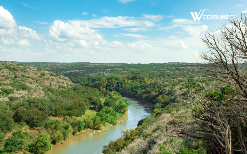 Colorado River winding through wooded hills at Colorado Bend State Park in Texas