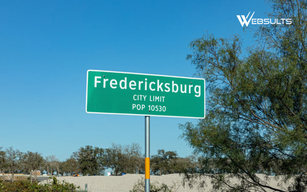 Fredericksburg, Texas, city limit sign against a clear blue sky