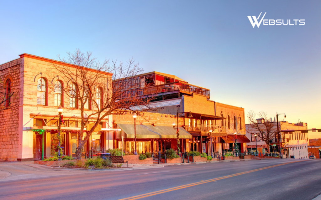 Historic downtown San Marcos, Texas, storefronts along a sunlit street